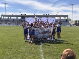 UCSB women's rugby team holding a trophy